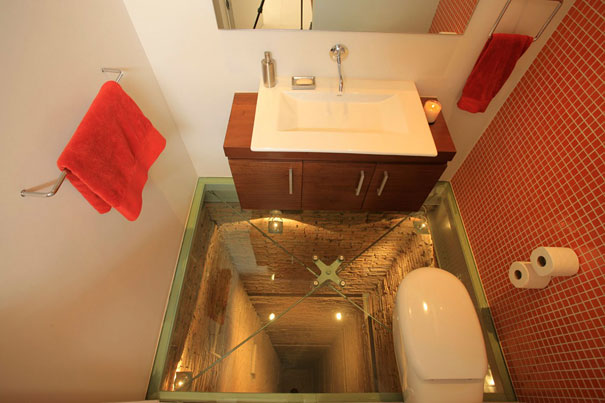 This glass floor bathroom sits atop 15 story elevator shaft! Scary!